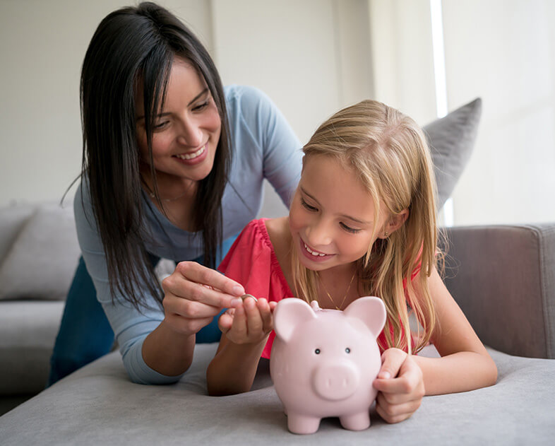 mother and daughter with piggy bank