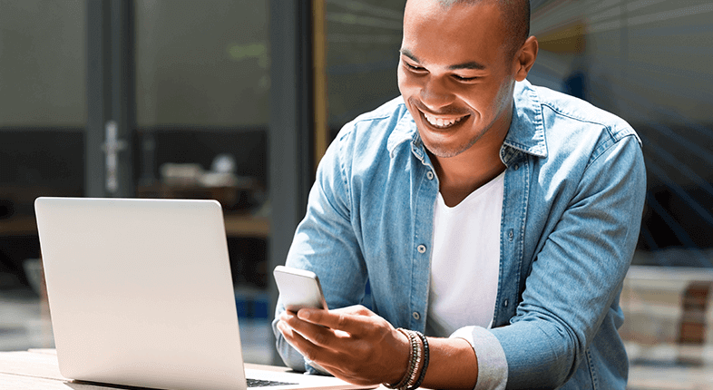 smiling man looking at phone