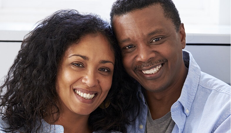 husband and wife smiling