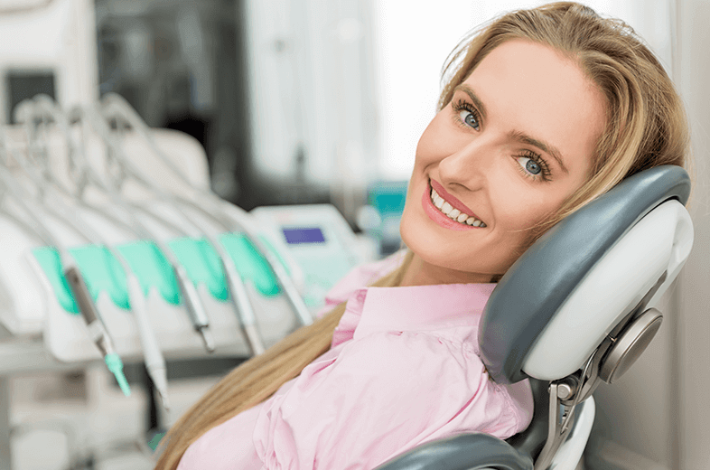 smiling woman in dental chair