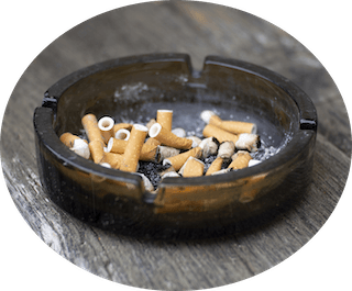 Ashtray with used cigarettes contains tobacco that cause oral cancer
