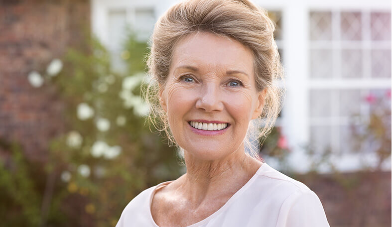 senior woman with dentures smiling