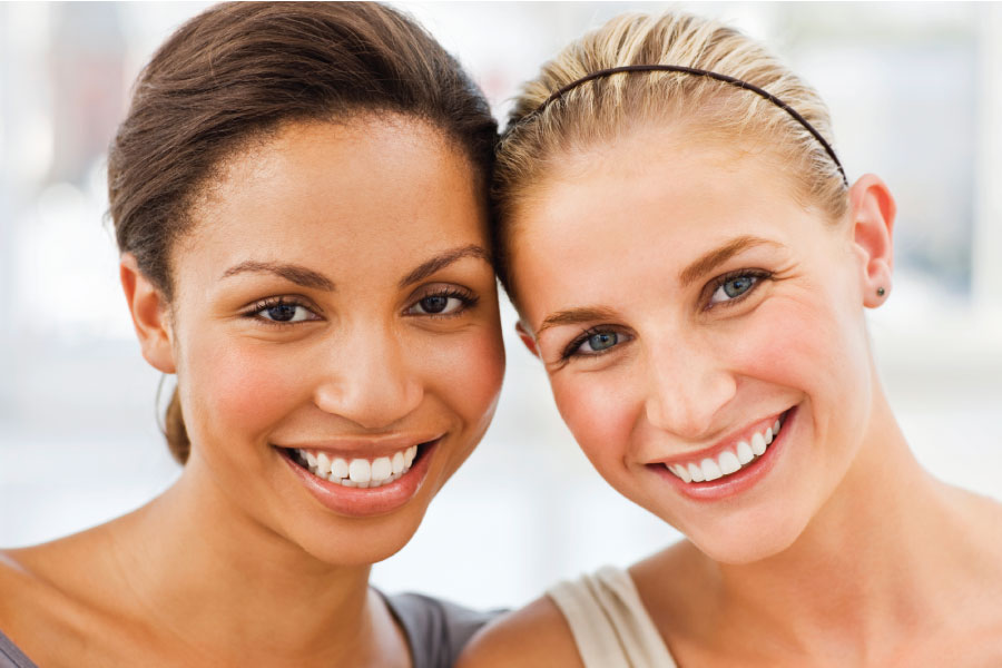 Two women smile after professional teeth whitening in Westerville, OH, at Sean Abidin, DDS & Vanessa Cao, DDS