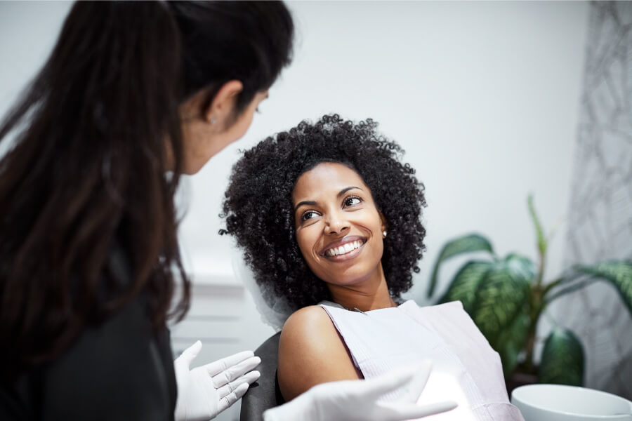 Curly-haired woman smiles after finding a great family dentist in Westerville, OH